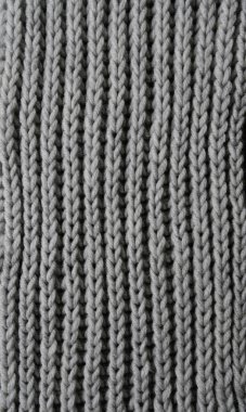 Merino örgü battaniyesinden gri doku arka planı, kopya alanı olan İskandinav minimalizmi arka planı, üst görünüm. Soyut örgü kumaş arka planı. Dikey konsept