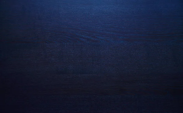 Holz braun, blaue Maserung, dunkler Wandhintergrund, Ansicht des Holztisches von oben — Stockfoto