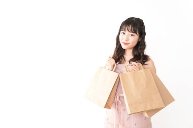 Beyaz arka planda izole edilmiş kağıt torbaları tutan Asyalı genç kadın portresi