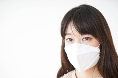 Yüz maskeli genç Asyalı kadın. 