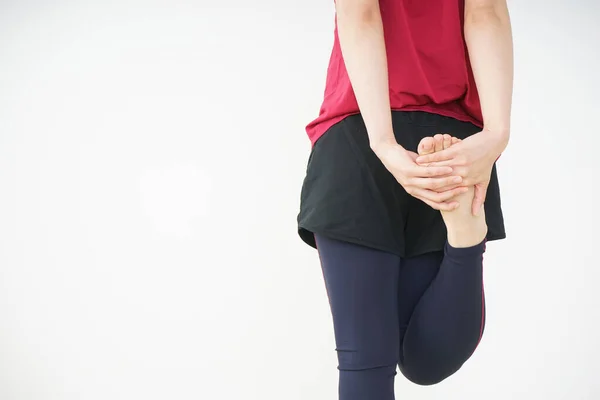 stock image portrait of sporty Asian woman stretching at home