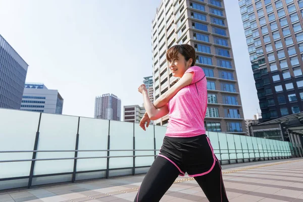 portrait of sporty Asian woman exercising in the city