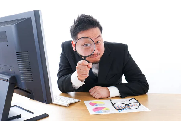 Young Businessman Looking Magnifying Glass While Sitting Table Stock Picture