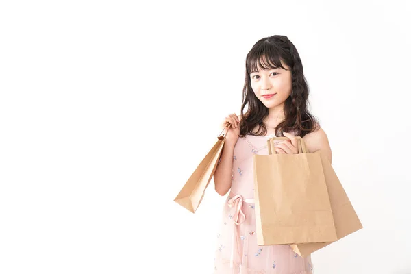 白い背景に孤立した紙袋を持ったアジア系の若い女性の肖像画 — ストック写真