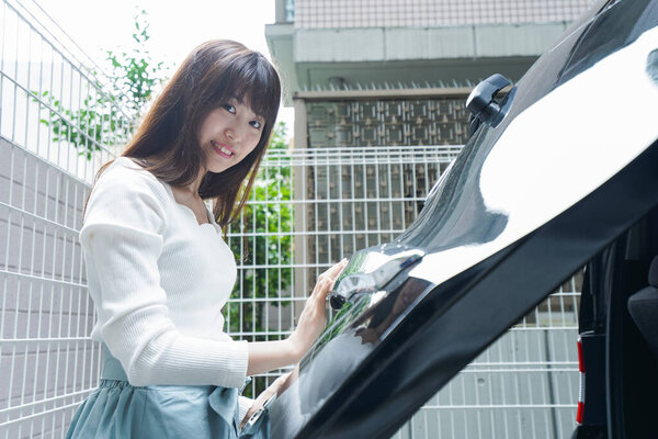 young asian woman with a car