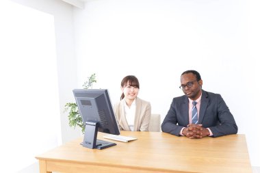 Genç iş adamları bilgisayar kullanarak iş konuşuyorlar