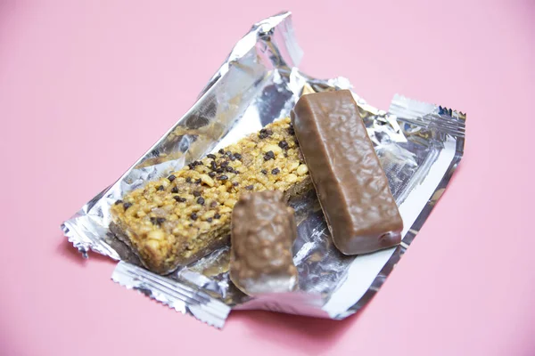 chocolate protein bar healthy food on a pink background.