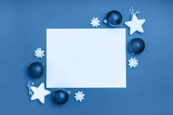 Nový rok a vánoční rámová skladba. Prázdný list papíru s vánoční výzdobou na modrém pozadí. Horní pohled, plochá poloha, kopírovací prostor — Stock fotografie