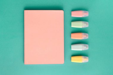 Pastel okul malzemeleri, defter ve arkaplanda işaretler. Üst manzara, düz yatış, yukarıdan. Okula geri dön..