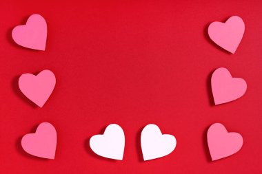 Kırmızı yüzeyde sevgililer günü kalpleri. Üst görünüm, düz görünüm, yukarıdan, boşluğu kopyala