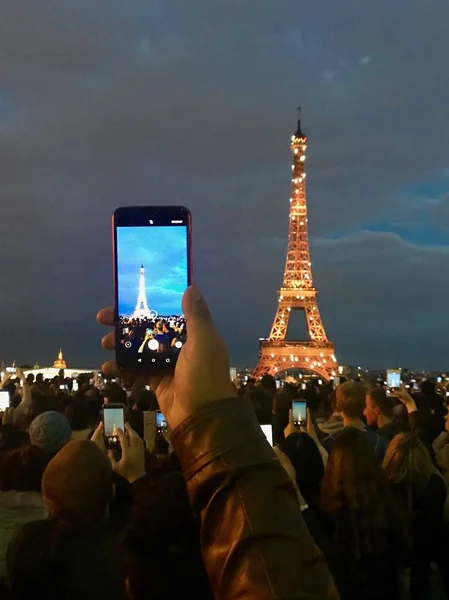 Photo on theme large Eiffel Tower on surface earth in garden Par — Stock Photo, Image