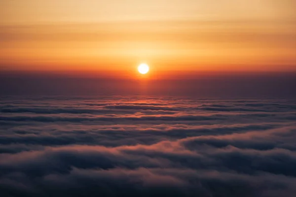 stock image The setting sun sets in low clouds off the coast of Anapa. In May, due to the temperature difference between water and the atmosphere, clouds fall almost to sea level. Anapa, Black Sea