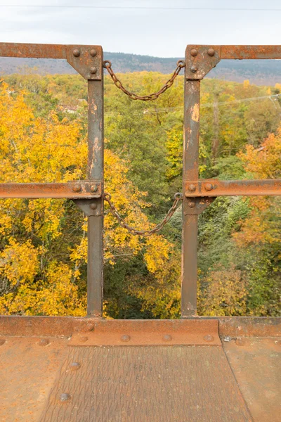Metal fence is not a background of yellow foliage trees. — Stock Photo, Image