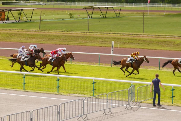 Horses and riders during galloping races at the racetrack. Hippodrome of France, the city of Divonne les ban. July 14, 2016 — Stock Photo, Image