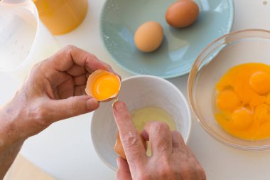 kırık yumurta. Erkek arka plandaki tabloda break yumurta gereçleri ile eller.