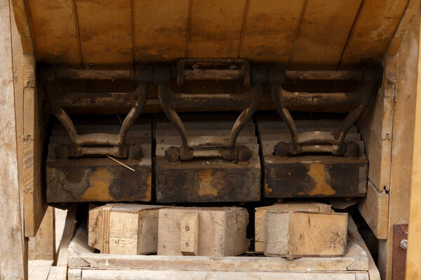 Part of an old machine for processing mowed cereals. Old farm machine.