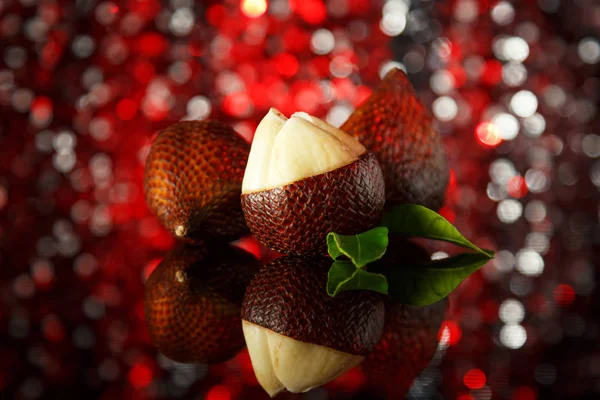 snake fruit on a festive background with bokeh. beautiful edible exotic fruits. gourmet food for vegans