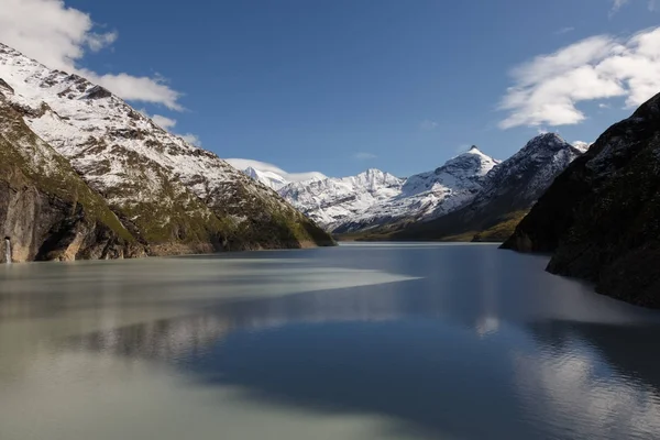 beautiful view of the mountain peak with snow. Swiss Alps with a clean lake.