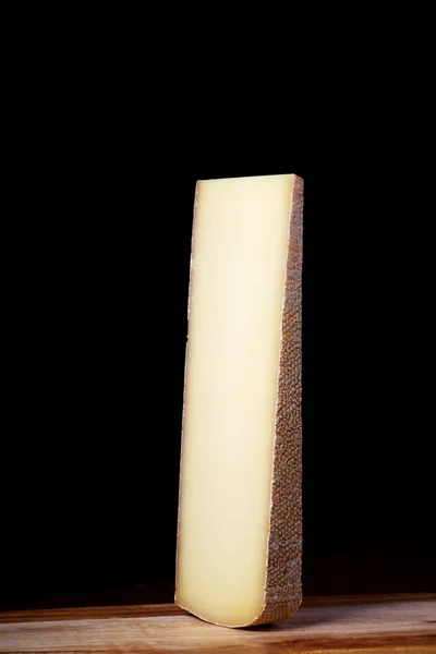 黑色背景上的一大块瑞士奶酪 奶类产品 — 图库照片
