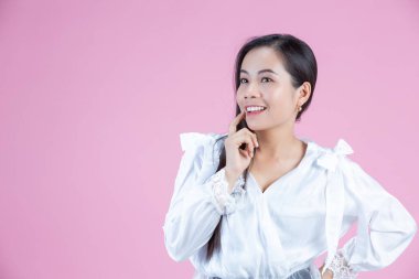 happy woman with index finger on her chin 