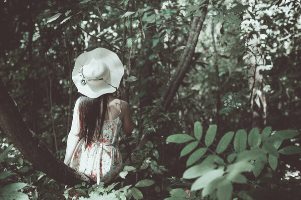 Vintage picture of the happiness girl wearing a straw hat in the garden