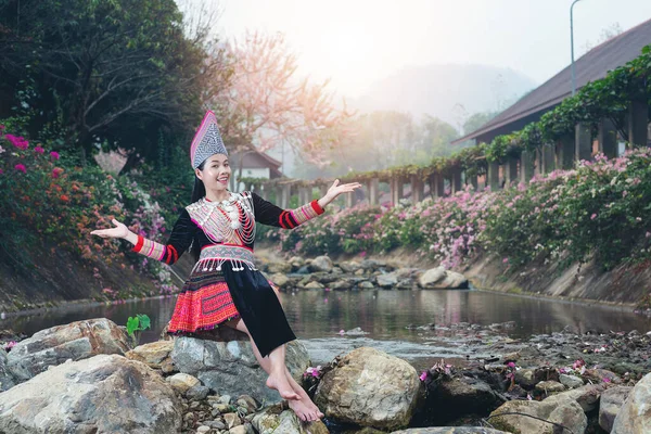 tribal beautiful womanan in  traditional outfit beside the river