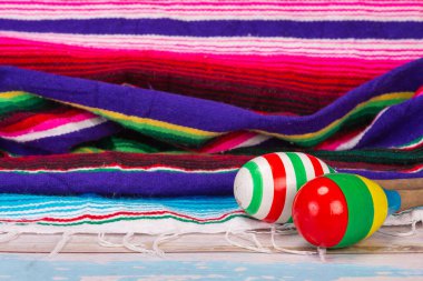 colorful Mexican maraca put on light color wooden floor