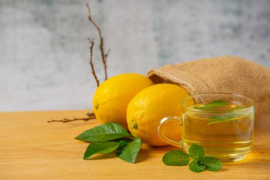 fresh lemon on a wooden cutting board and lemon juice