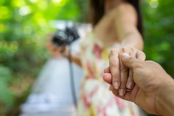 man holding woman hand with passionate during go out to taking photo
