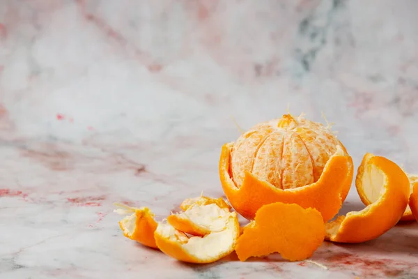 Fresh oranges, peeled oranges and pieces of oranges