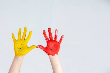 The hands of the child who smeared on the gray background.