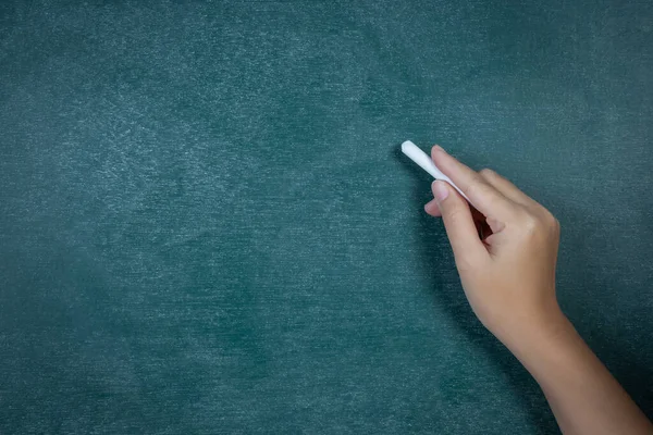 white chalk in hand in front of backboard