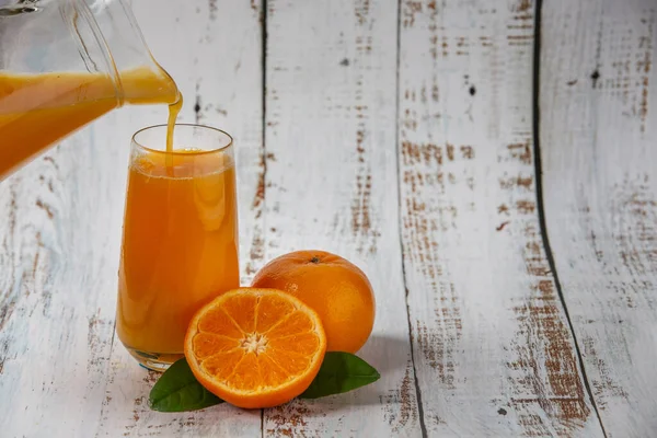 orange juice pouring orange juice on glass