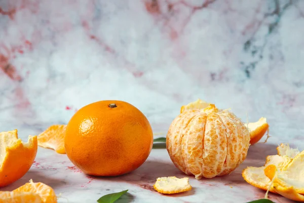 Fresh oranges, peeled oranges and pieces of oranges