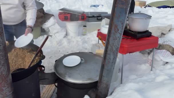 Simple Meal Cook Puts Buckwheat Porridge Plates Large Cauldron Siberia — Stock Video