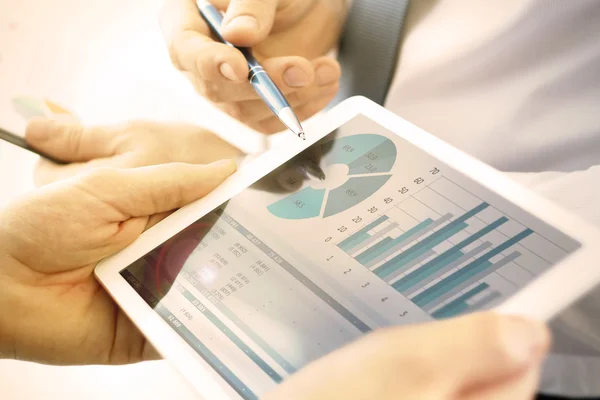 Business colleagues working and analyzing financial figures on a digital tablet — Stock Photo, Image