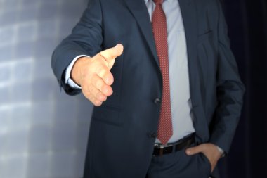 El sıkışma için genişletilmiş açık bir el ile bir iş adamı 