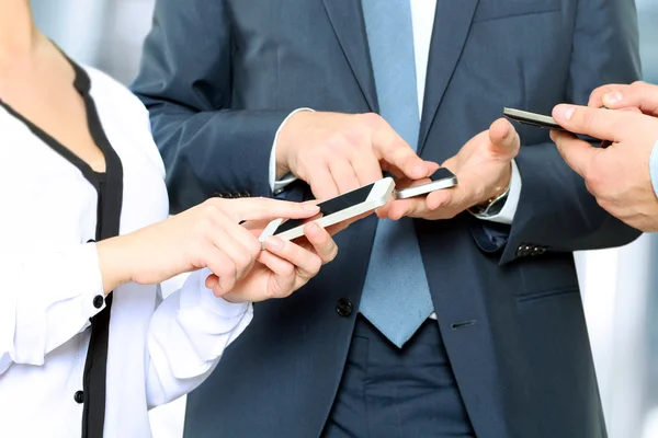 Close-up van een bedrijf mannen en vrouw met behulp van mobiele slimme telefoons — Stockfoto