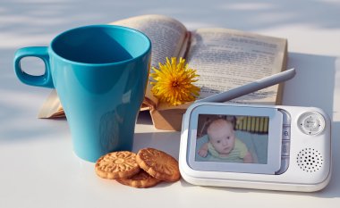 The clouse-up baby monitor for security of the baby on the table  clipart