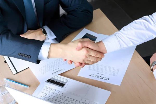 Close-up image of a firm handshake between two colleagues after signing a contract — Stock Photo, Image