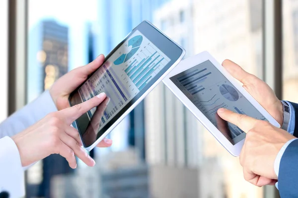 Business woman  and man working and analyzing financial figures on a graphs — Stock Photo, Image