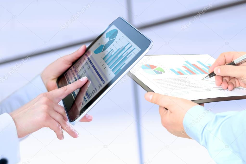 Business woman  and man working and analyzing financial figures on a graphs