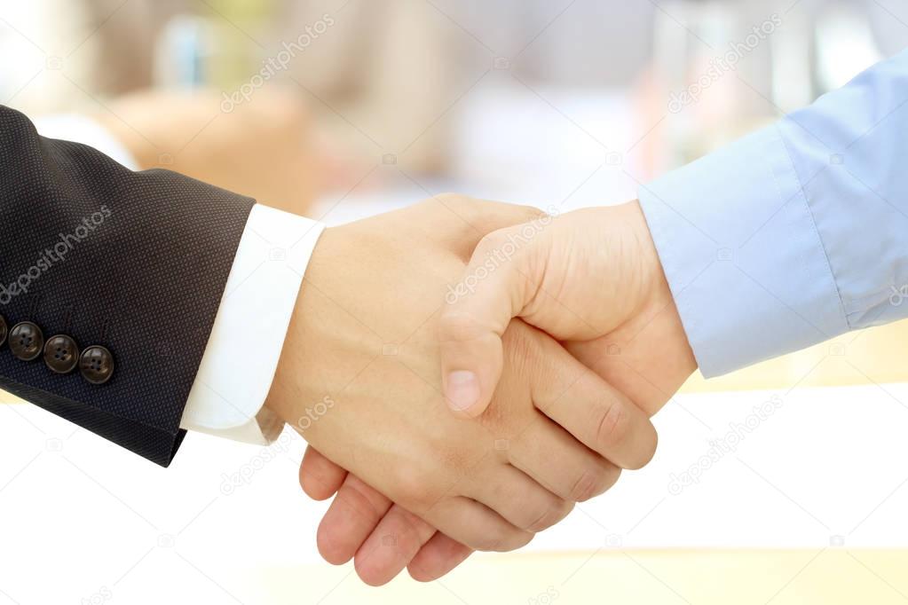 Close-up image of a firm handshake between two colleagues 