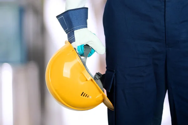 Worker in a construction site with yellow helmet — Stock Photo, Image