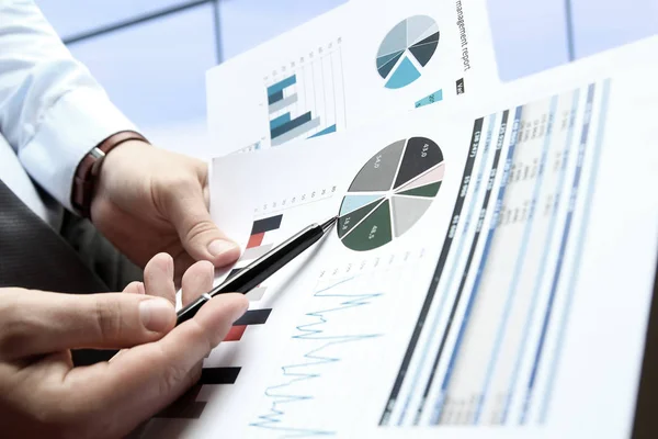 Geschäftsmann arbeitet und analysiert Finanzzahlen auf einer Graphik. — Stockfoto