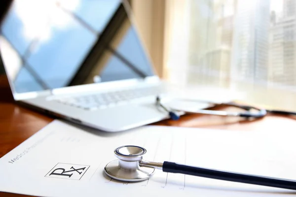 Prescription, laptop and phonendoscope at the doctor`s table — Stock Photo, Image