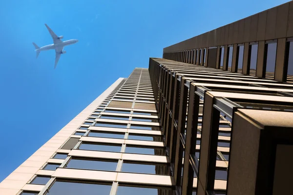 Modern business buildings. Skyscrapers. Airplaine — Stock Photo, Image