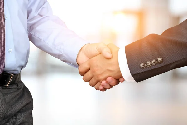 Närbild bilden av ett fast handslag mellan två kollegor på vit bakgrund — Stockfoto