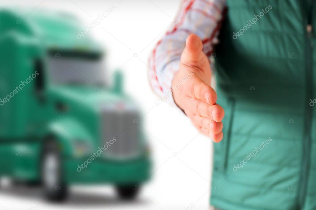 Driver with an open hand  greeting . Truck behind him