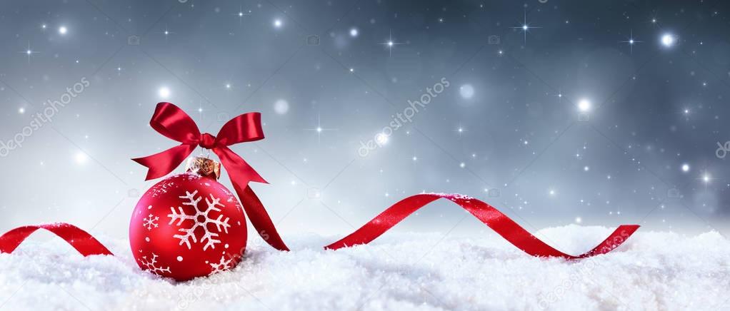Red Sphere With Bow And Ribbon On Snow - Christmas Card